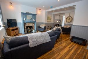 a living room with a couch and a fireplace at Gelly Cott in Padstow