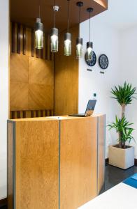 an office with a reception desk with a laptop on it at R&R Hotel in Yerevan