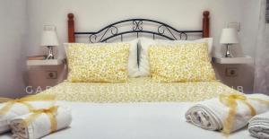 a bedroom with a bed with yellow bows on it at Vv CASA JULIANA- Coqueta casa entre montañas. in La Aldea de San Nicolas