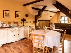 a kitchen and dining room with a table and chairs at B&B OLEN in Olen