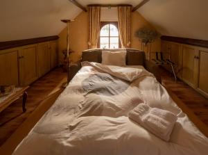 a large white bed in a room with a window at B&B OLEN in Olen