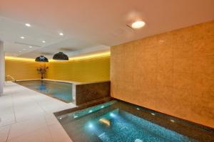 an indoor swimming pool in a hotel room at HOLM Boutique & SPA - IK Collection in St. Julianʼs