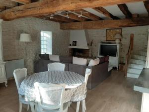 a living room with a table and a couch at Le Petit bois in Niort