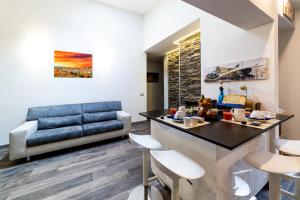 a living room with a blue couch and a table at Medici Soderini in Florence