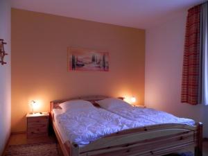 a bedroom with a bed with two lamps on it at Ferienbungalow Nähe Willingen-Winterberg in Medebach
