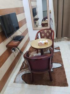 Una televisión o centro de entretenimiento en Beit Almurooj Hotel Apartment