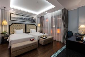 
a hotel room with a large bed and a large window at Babylon Premium Hotel & Spa in Hanoi
