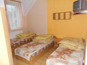 
Łóżko lub łóżka w pokoju w obiekcie NSSM Tanie Spanie
