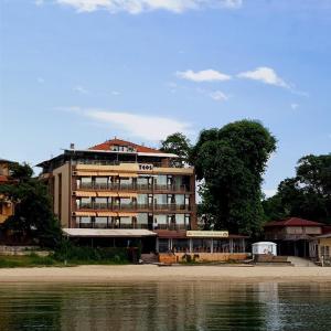 a large building next to a body of water at Family Hotel Teos in Kiten