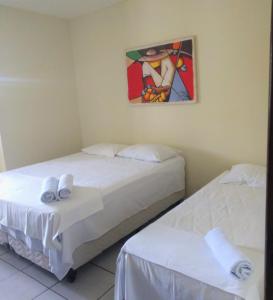 A bed or beds in a room at Hotel Beira Rio Preguiças