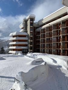 a building covered in snow in front of a building at Casa Camas, wide 2bedroom, feel the mountain in Breuil-Cervinia