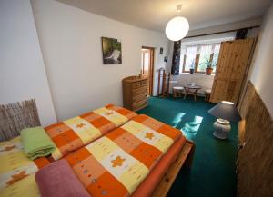 a bedroom with two twin beds and a table at VegZion - vegan B&B in Svoboda nad Úpou