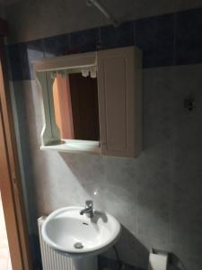 a bathroom with a sink and a medicine cabinet at G M 6 ROOMS KENTRO in the heart of the city in Larisa +9 photos