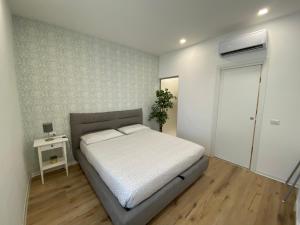 a bedroom with a bed and a table and a door at Antico Palazzo Lago Maggiore in Verbania