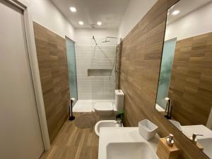 a bathroom with two sinks and a toilet and a shower at Antico Palazzo Lago Maggiore in Verbania +26 photos