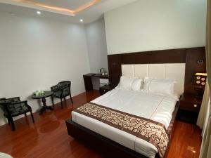 Un dormitorio con una cama y una mesa y sillas. en Afro legacy hotel, en Addis Ababa
