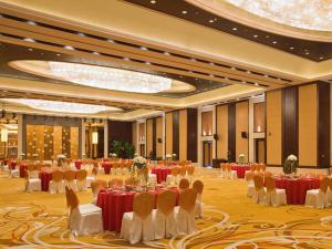 a banquet hall with tables and chairs in a room at Hotel Shanghai Sheshan Oriental - Handwritten Collection in Songjiang