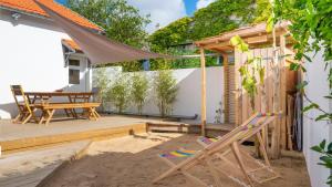 a patio with a table and chairs and a tent at Ravissante maison 300 Mètres de la plage in Notre-Dame-de-Monts