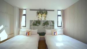 Katil atau katil-katil dalam bilik di Ouxiang Manor Hotel