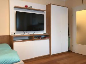 a living room with a tv on a white wall at Apartment.Kirche in Sankt Georgen ob Murau