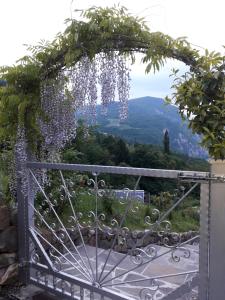 a garden gate with a view of the mountains at ATL AGRITURISMO in Salorno sulla Strada del Vino