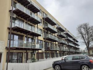 a car parked in front of a building with balconies at Beta Residence Saturn in Mangalia
