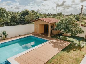 a swimming pool in the backyard of a house at Mansão Beberibe in Beberibe