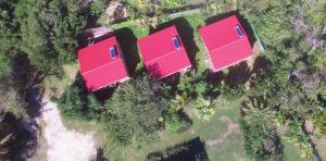an overhead view of three houses with pink roofs at Les Z’Alizés in Le Moule