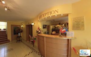 a bar in a restaurant with a sign that reads anticipation at Hotel Valul Magic in Eforie Nord