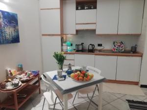 a kitchen with a table with a bowl of fruit on it at DonnaBarbara in Vernazza +24 photos