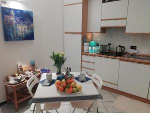a kitchen with a table with a bowl of fruit on it at DonnaBarbara in Vernazza