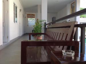 a wooden bench sitting in the hallway of a house at Grandma Kaew House in Chiang Rai