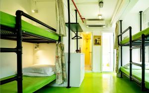 a room with three bunk beds and a hallway at Yesinn @YMT in Hong Kong