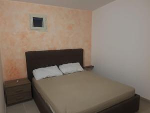 a bed with two white pillows in a bedroom at villa relax sul mare in Gallipoli