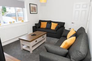 a living room with a couch and a coffee table at Charming 2 Bedroom House - Free Parking - Great Location in Tamworth