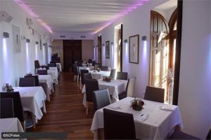 a row of tables in a restaurant with white tables and chairs at Calle Atlantico 108 1b Appartement in Sucina