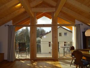 an open living room with a large sliding glass door at Ferienwohnung Seidlpark im Haus Ecker in Murnau am Staffelsee