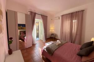 a bedroom with a large bed and a mirror at Casa Vacanze Antico Cassaro in Palermo +32 photos
