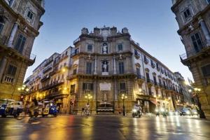 a large building on a city street at night at Casa Vacanze Antico Cassaro in Palermo