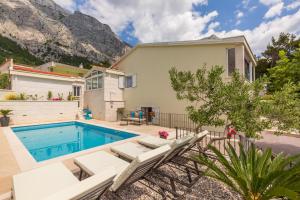 a villa with a swimming pool and a house at Villa Biston in Baška Voda