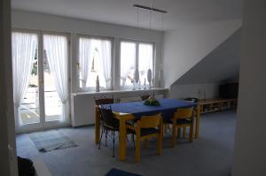 ein Esszimmer mit einem blauen Tisch und Stühlen in der Unterkunft Komfortferienwohnung in ruhiger Lage mit 128qm in Grömitz in Grömitz