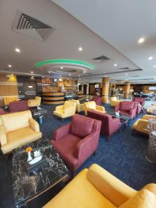 a library with couches and chairs in a room at Al Masem Rooms & Suites -Gurnata in Riyadh