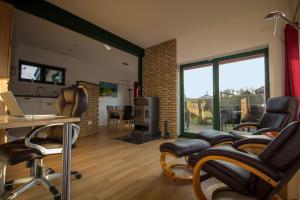 a living room with chairs and a table with a laptop at Ferienhaus Svala in Brodersby OT Schönhagen