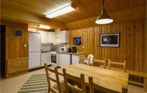 a kitchen and dining room with a wooden table and chairs at Amazing Home In Sysslebäck With Wifi in Sysslebäck
