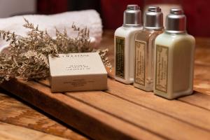 three bottles of essential oils sitting on a wooden table at Casa Chichipicas Hotel Boutique in Valle de Bravo