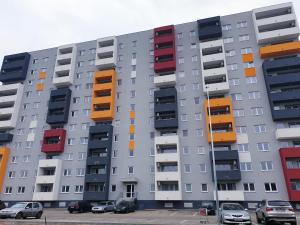 a building with colorful balconies on the side of it at Stefania Sweet Apartament in Oradea