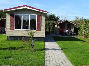 une maison avec un chemin menant à une cour dans l'établissement Camping de Ikeleane, à Bakkeveen