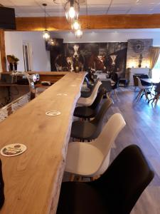a large wooden table and chairs in a room at Camping de Ikeleane in Bakkeveen