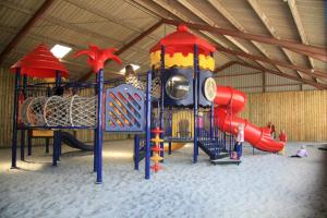 a play room with a playground with a slide at Camping de Ikeleane in Bakkeveen