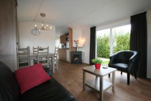 a living room with a couch and a table at Camping de Ikeleane in Bakkeveen